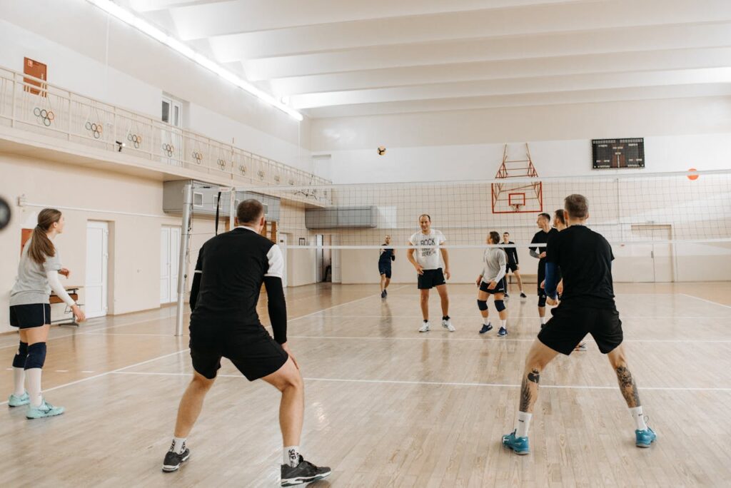 Energetic volleyball match with mixed team players engaging in a competitive game indoors.